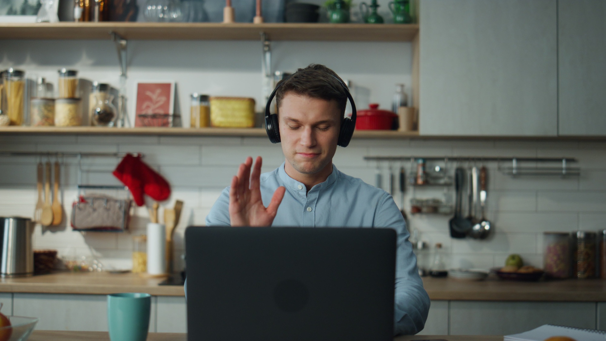 Remote worker saying goodbye to colleagues after video conference close up.